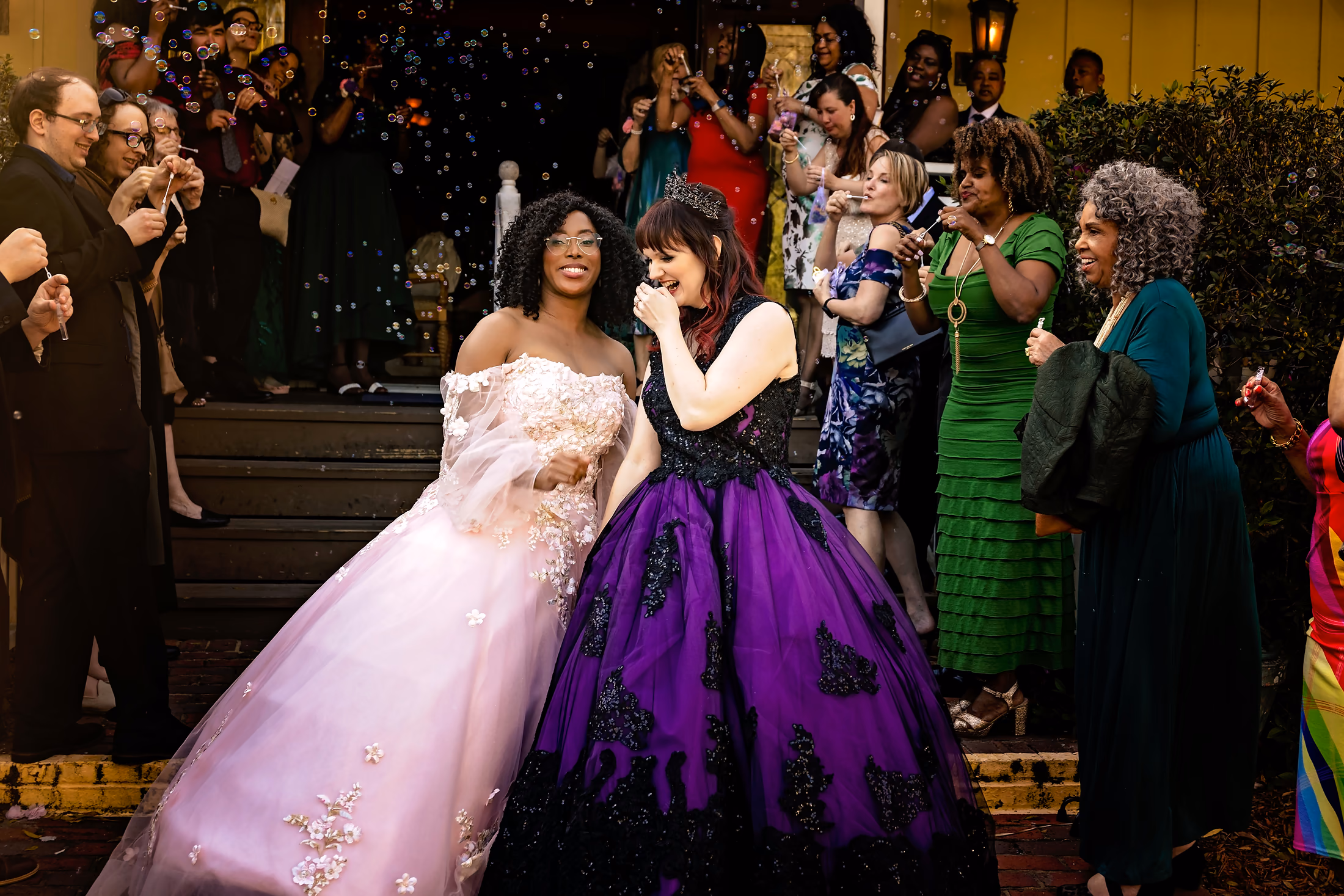 Two brides in ballgowns at a joyful send-off