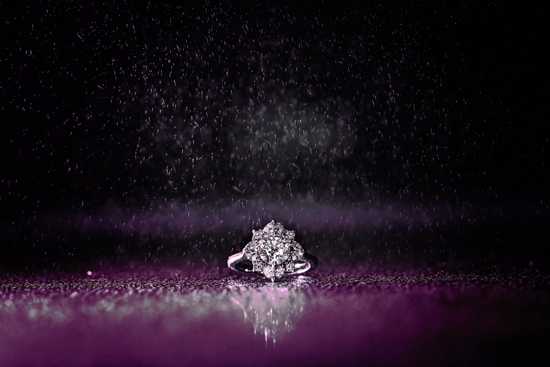 Wedding ring on a dewy dark surface