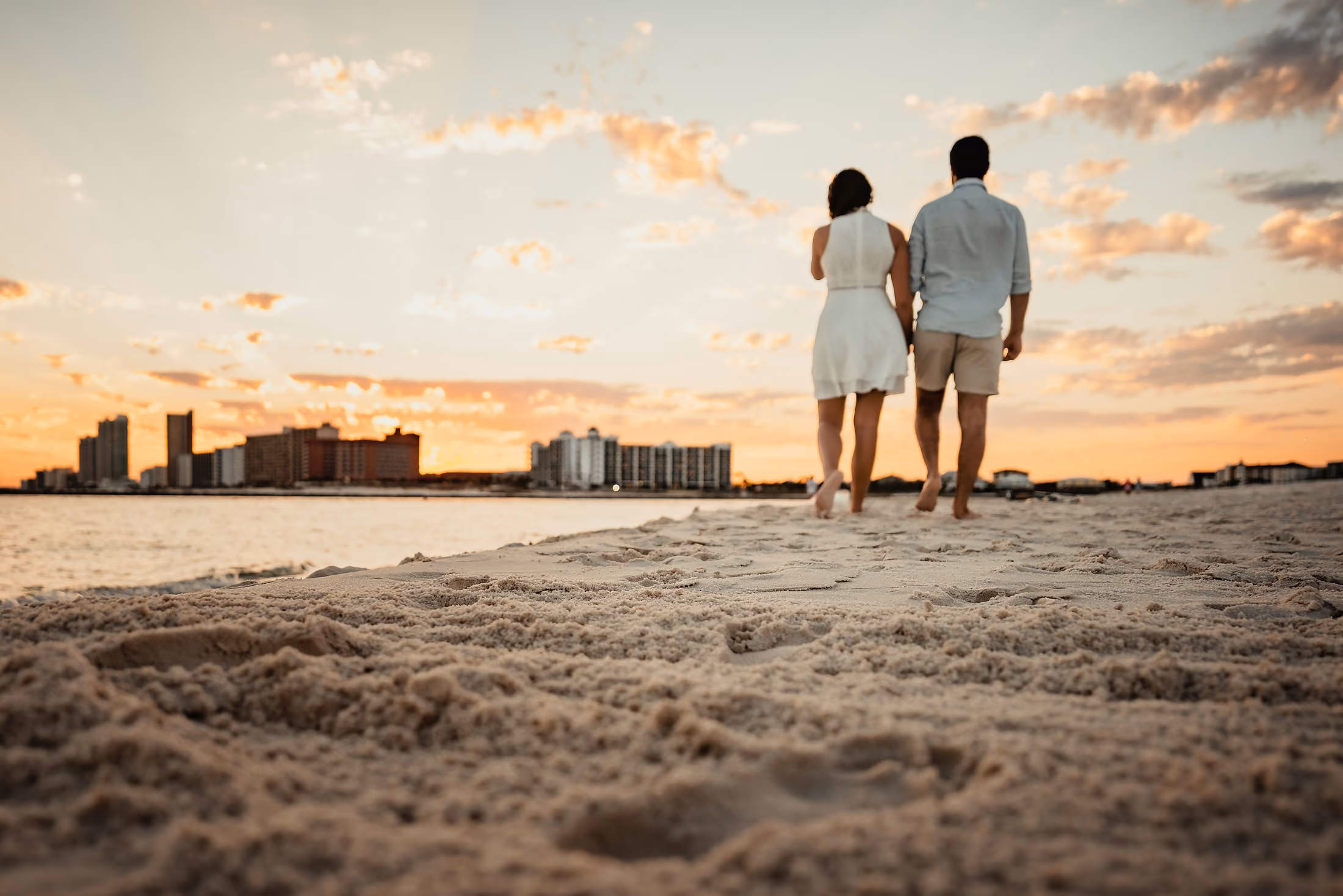 Couple looking out at the Gulf as the sun goes down