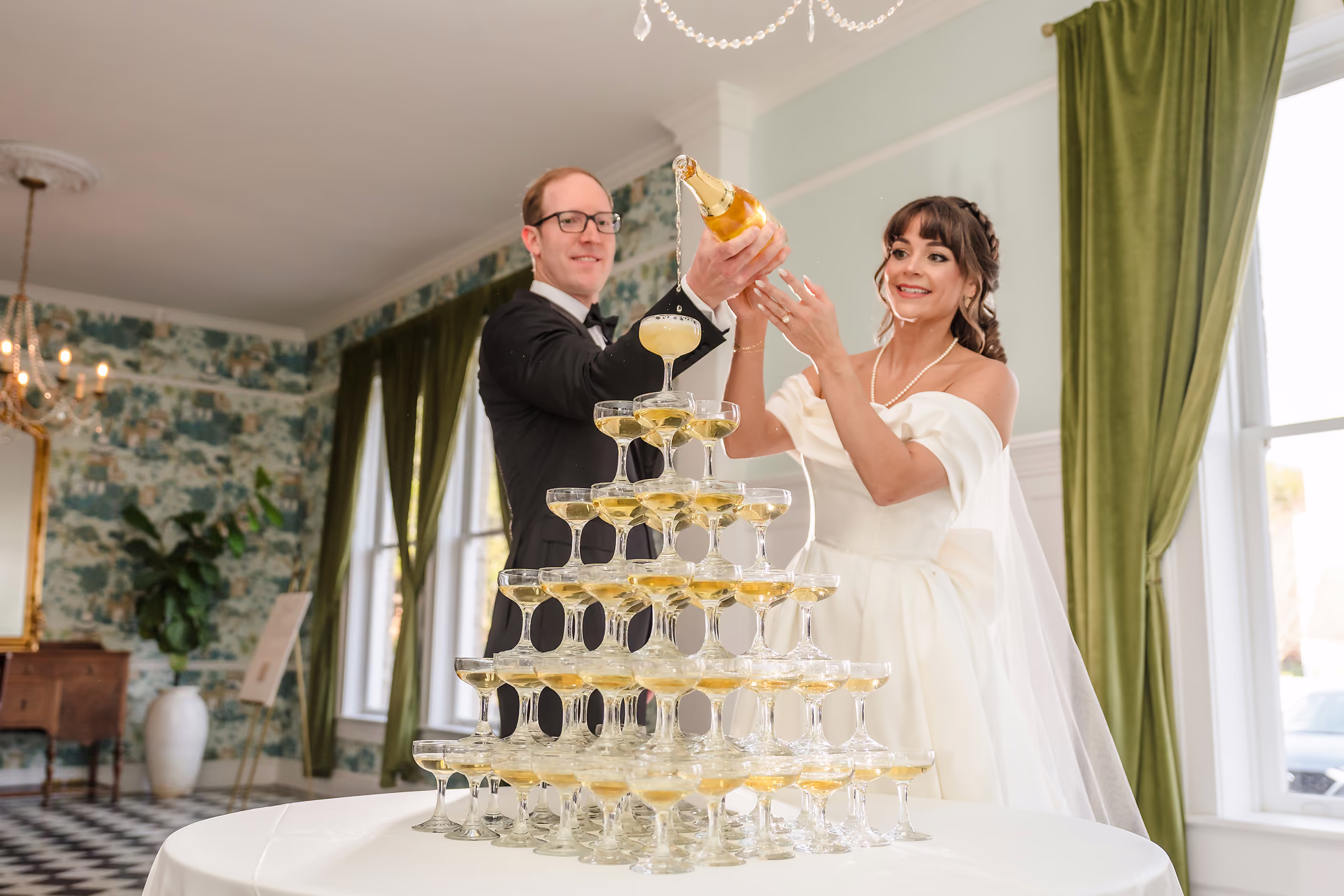 Couple toasting before a champagne tower