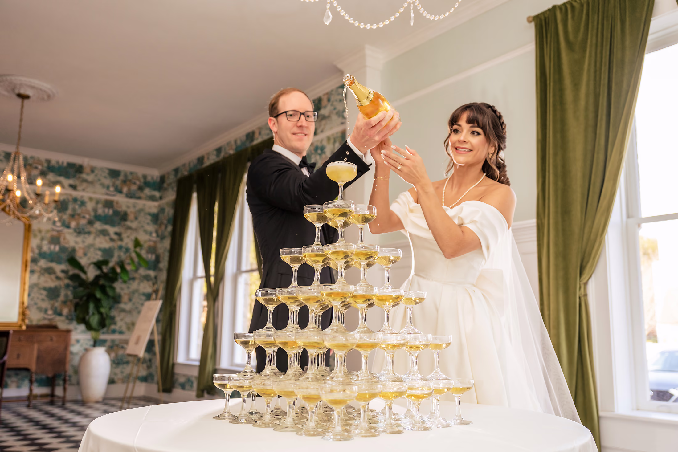 Champagne tower pour for the newlyweds
