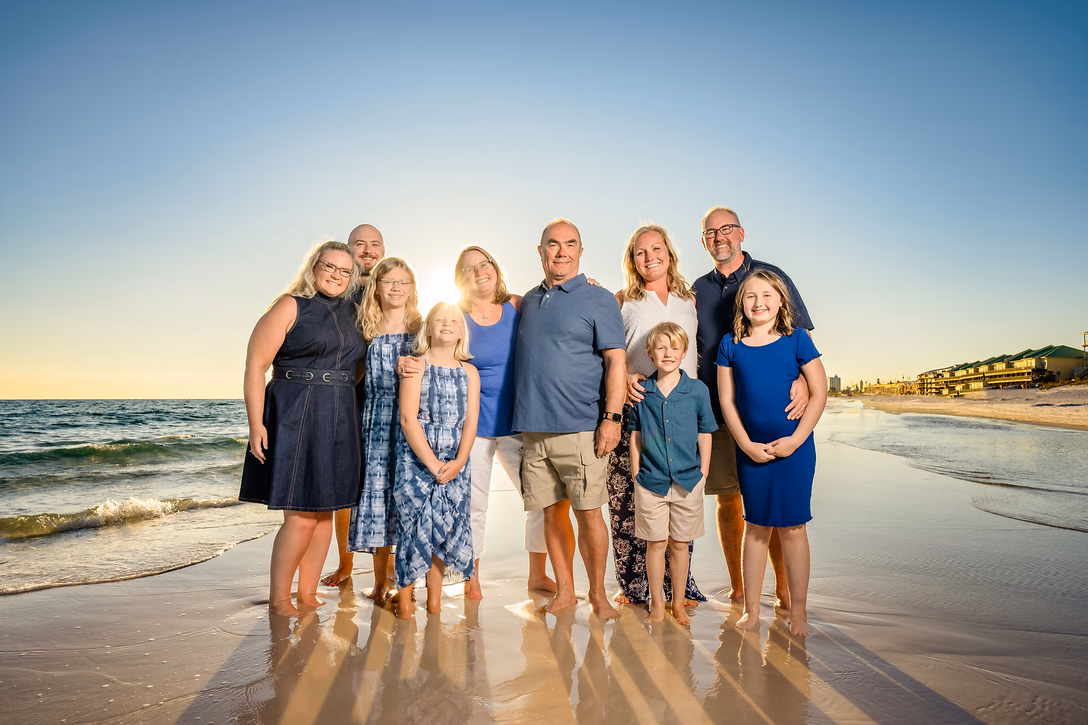 Extended family gathered on the beach at golden hour