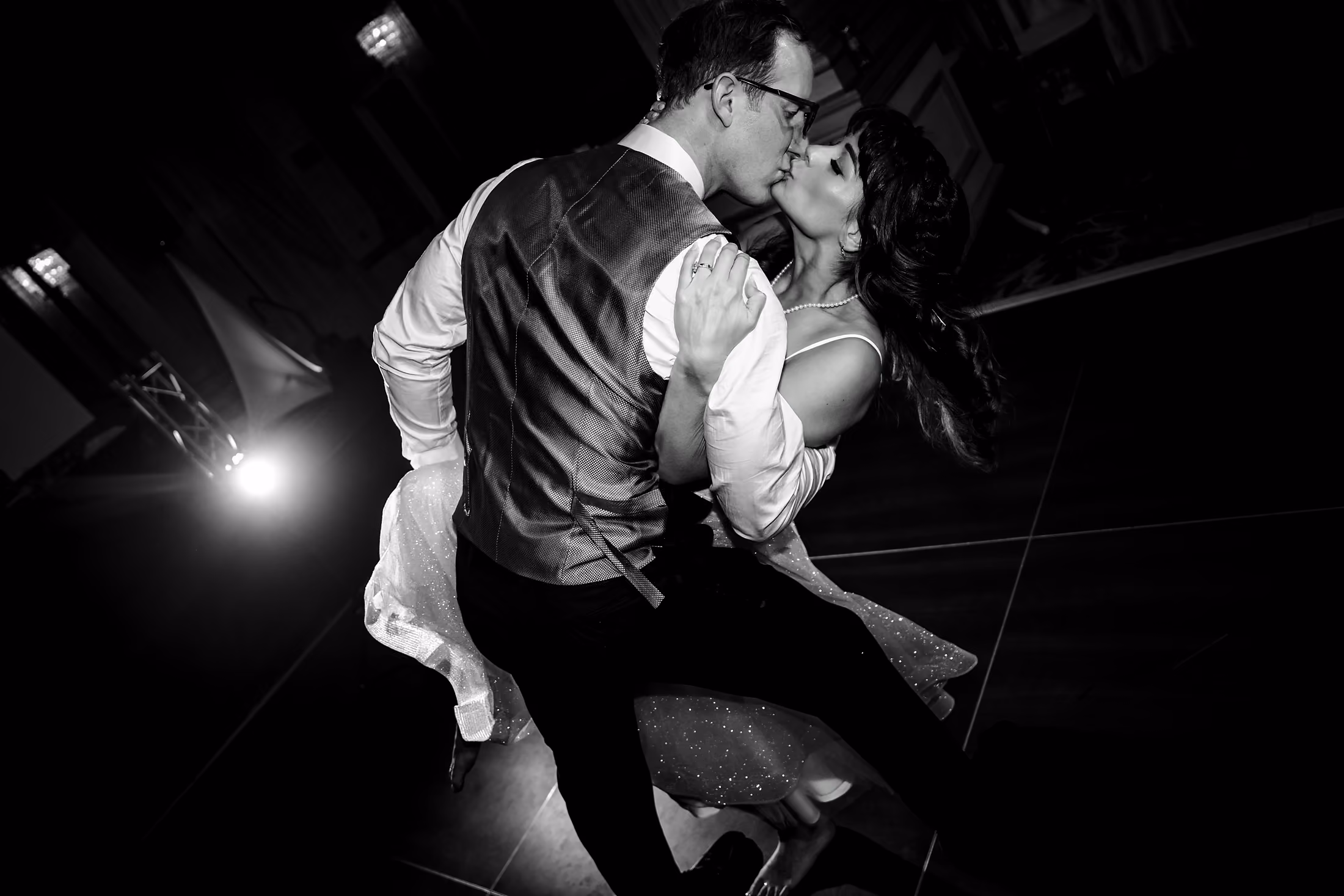 Black-and-white embrace in low light