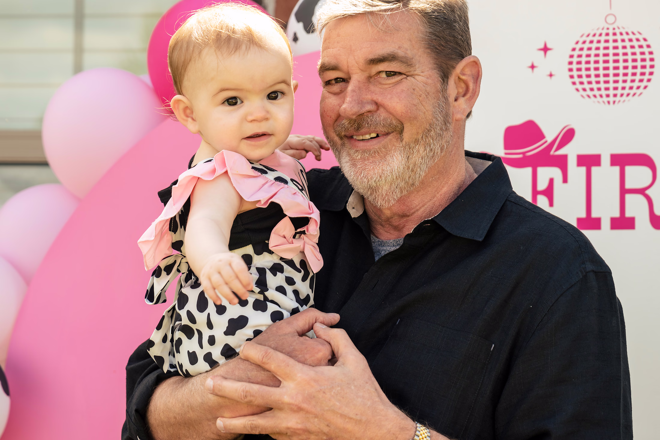 Grandfather holding the birthday girl at her first-birthday party