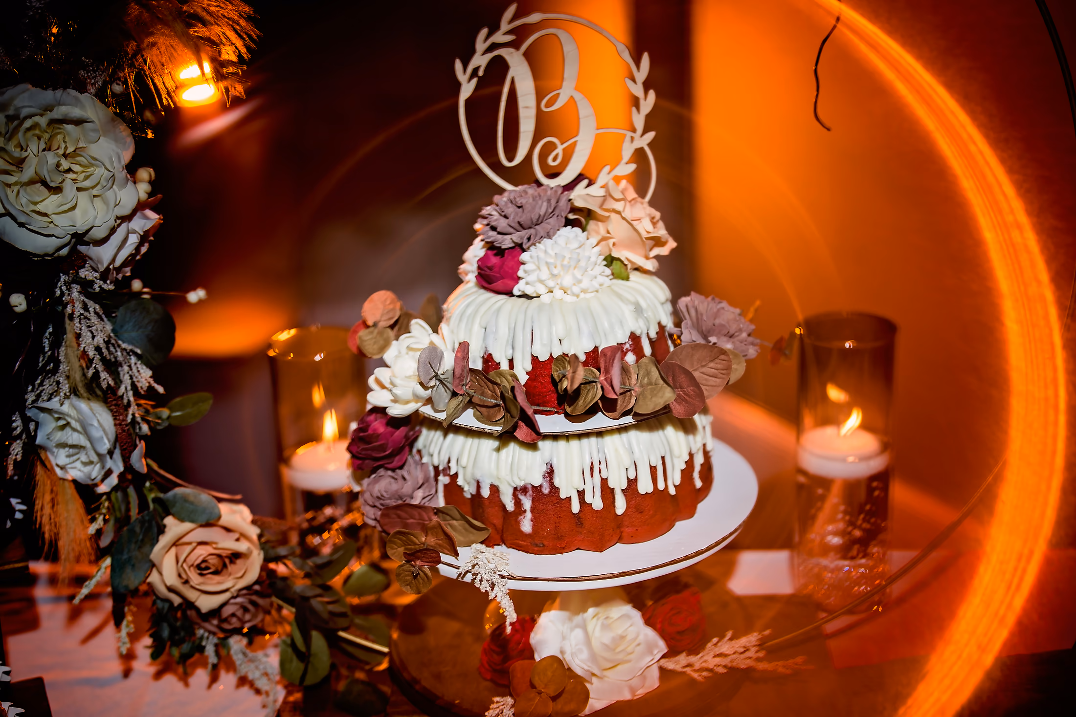 Wedding cake aglow in warm orange light