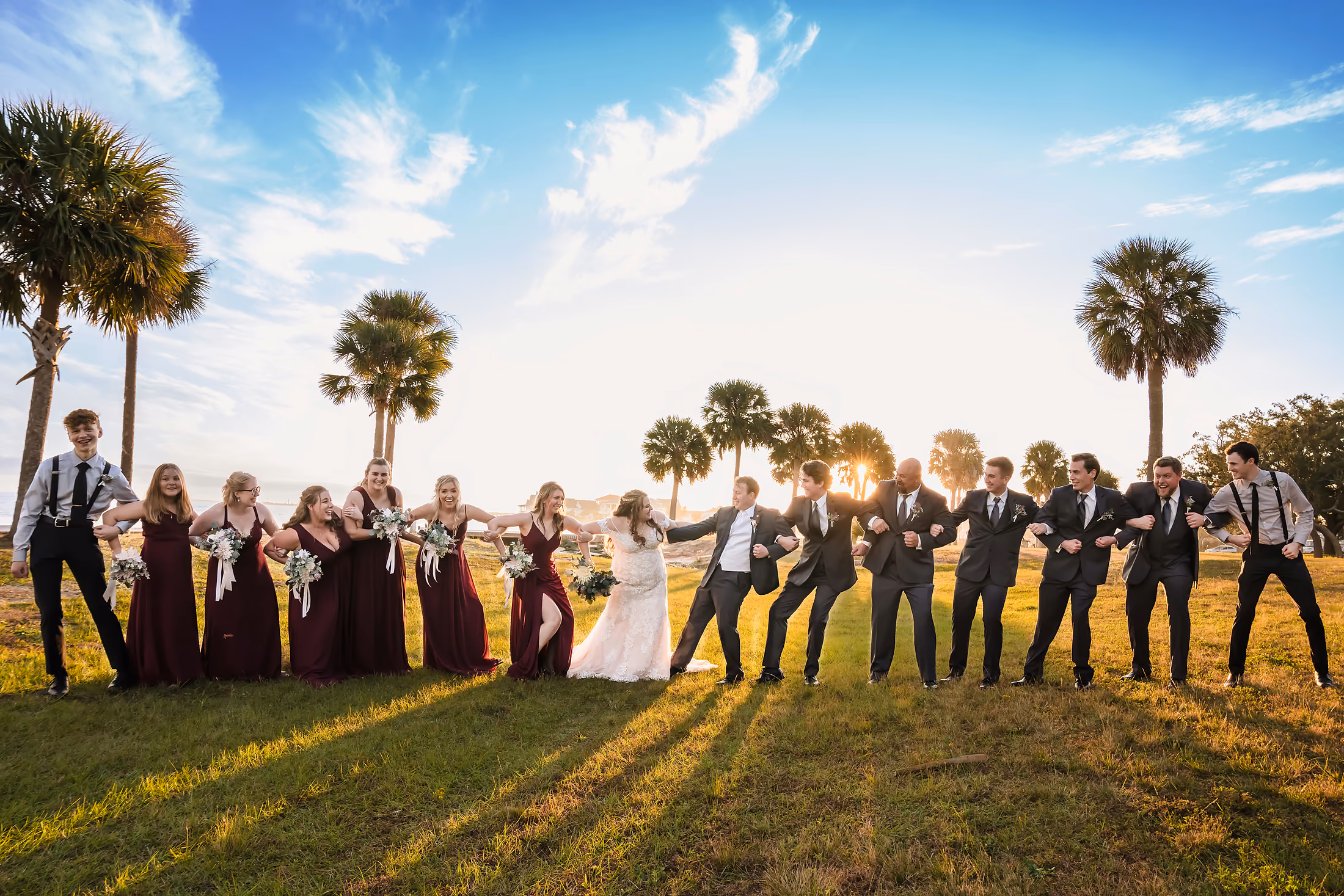Bridesmaids in blue along the shoreline