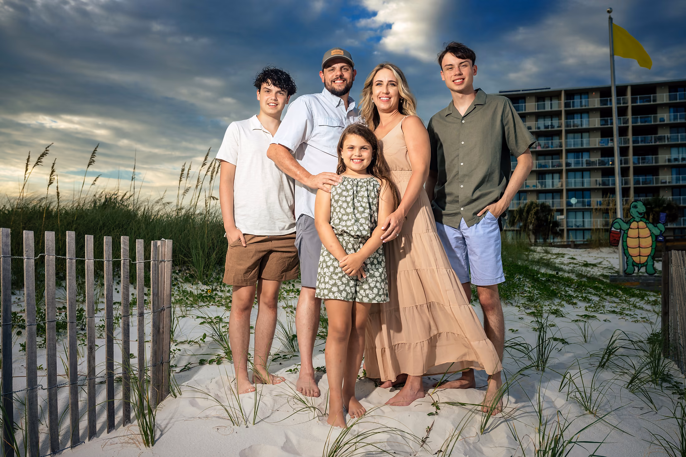 Family of five together by the dune fence
