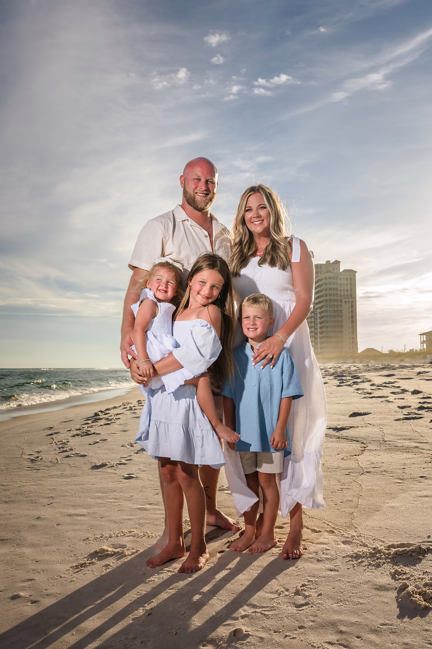 Family sitting together on the beach at golden hour