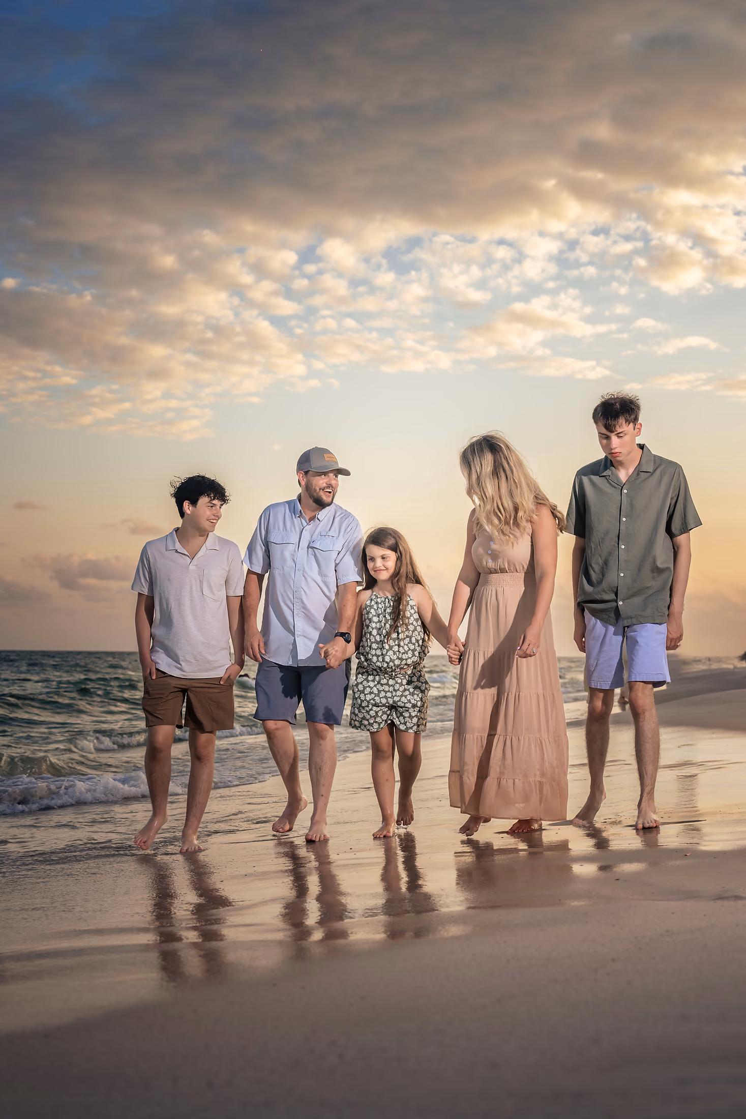 Family gathered far down the beach at dusk