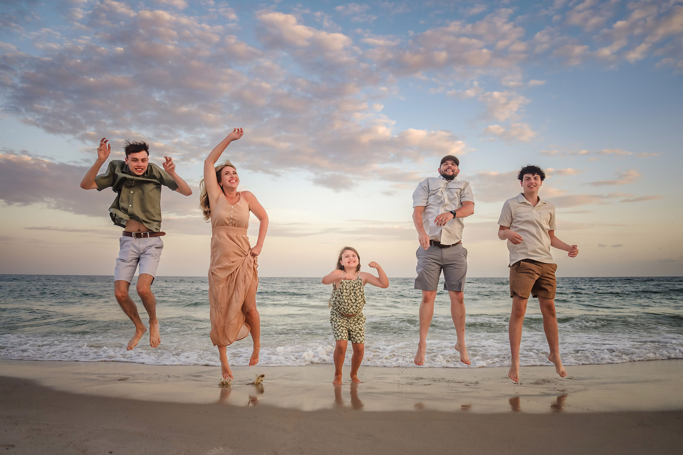 Family jumping together on the beach