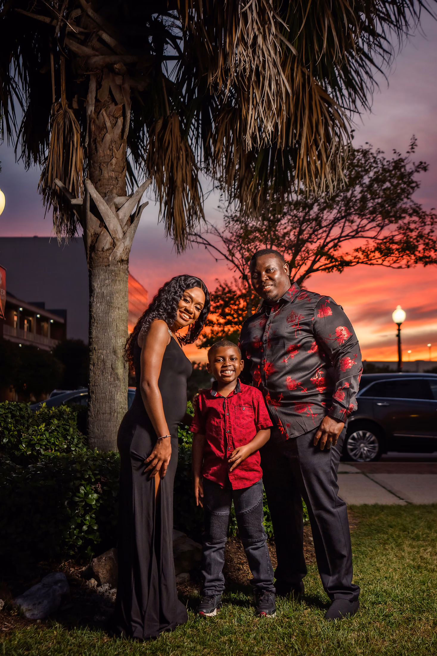 Family portrait among the palms in the evening