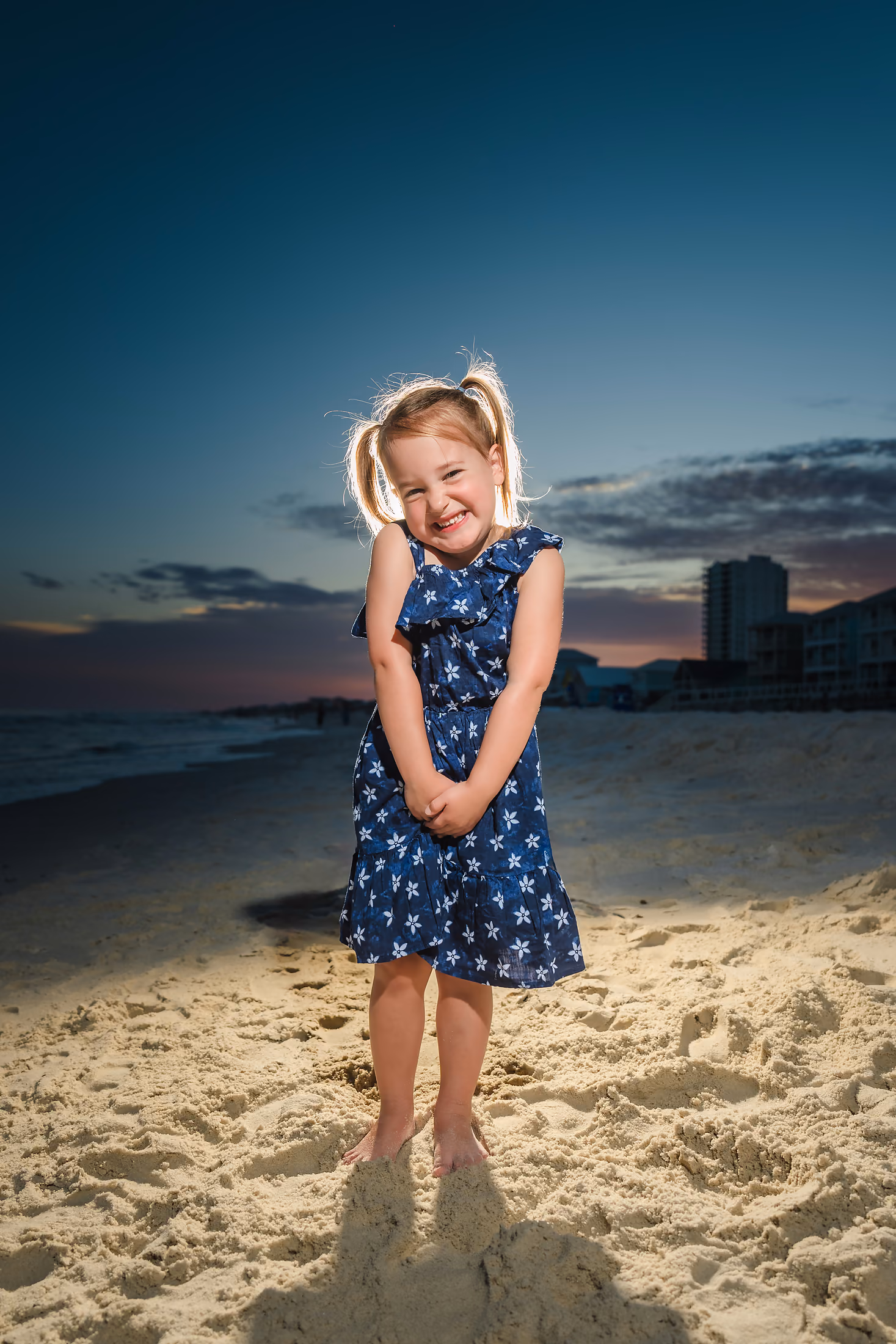 Little girl on the beach at dusk