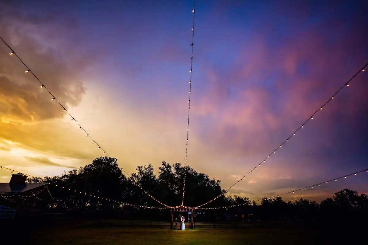 A kiss beneath a violet and amber sunset at Sowell Farms