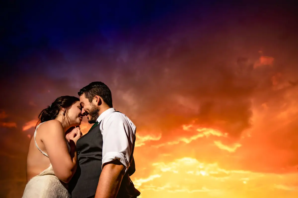 Bride and groom close together in the last warm light of the day