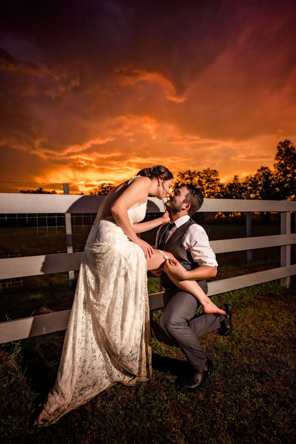 Bride leaning back in her groom's arms at golden hour, Sowell Farms