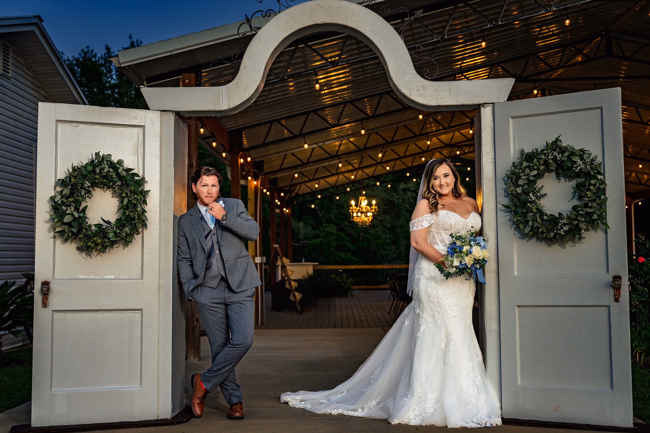 Bride and groom at the wreath-framed doors