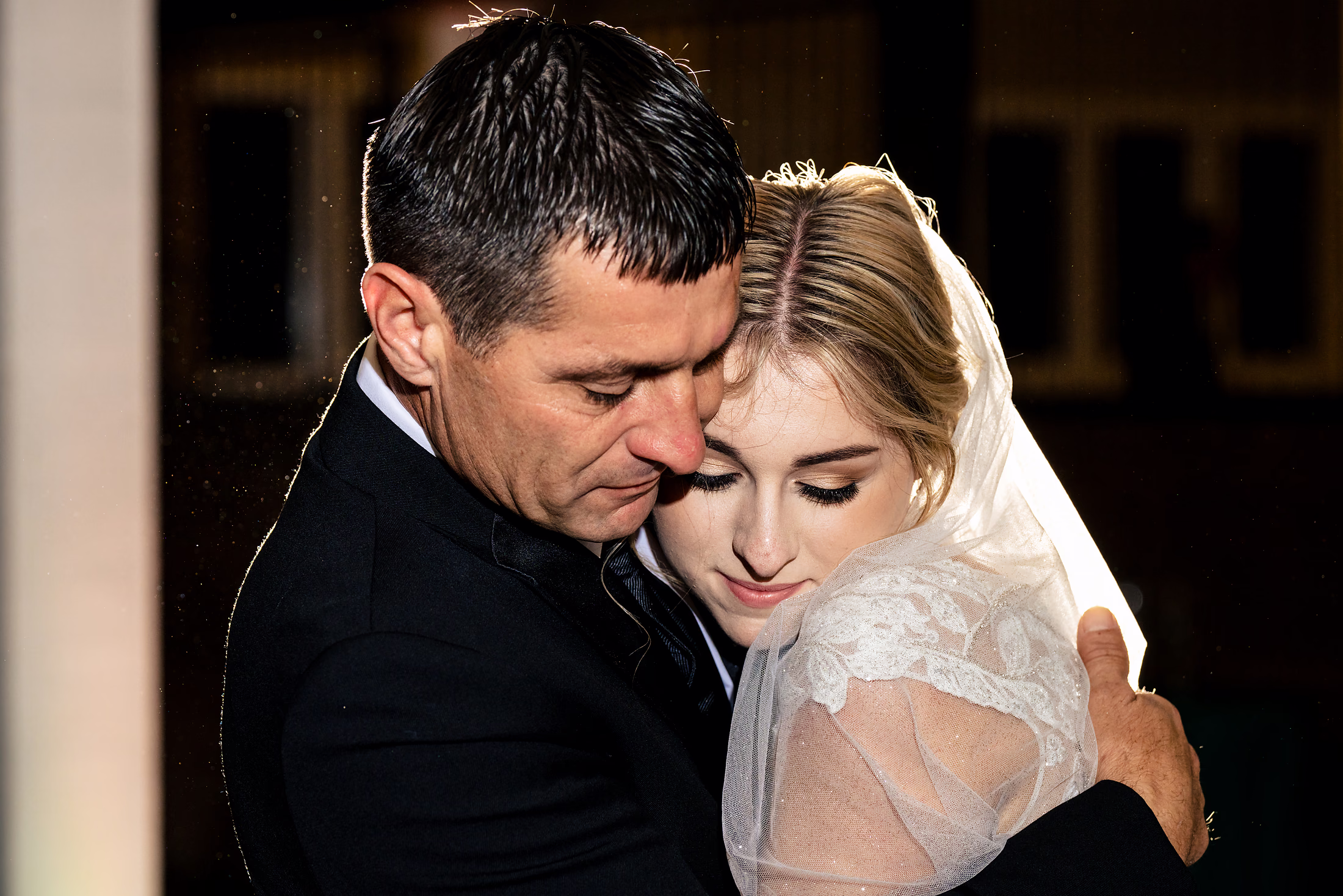 Couple close before a backdrop of string lights