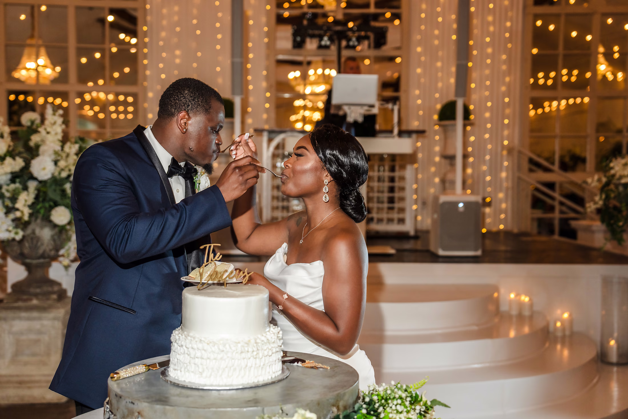 Cake cutting against the gold sequin wall
