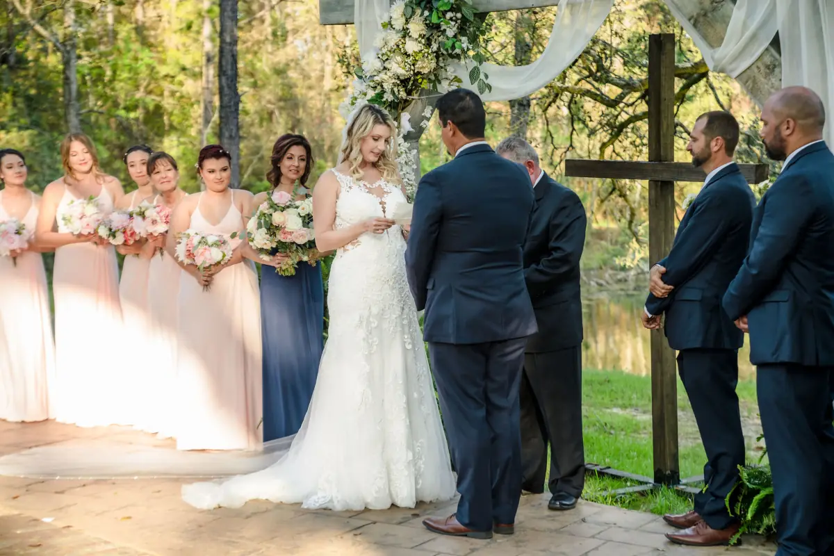 Bride and groom at the altar with their wedding party at Live Oak Plantation