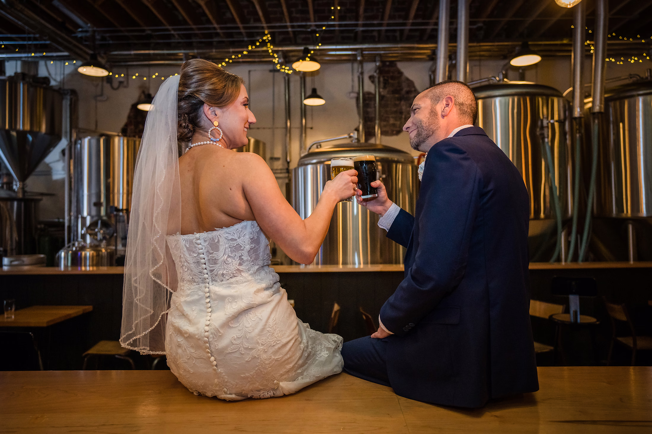 Bride and groom at the bar during their brewery reception