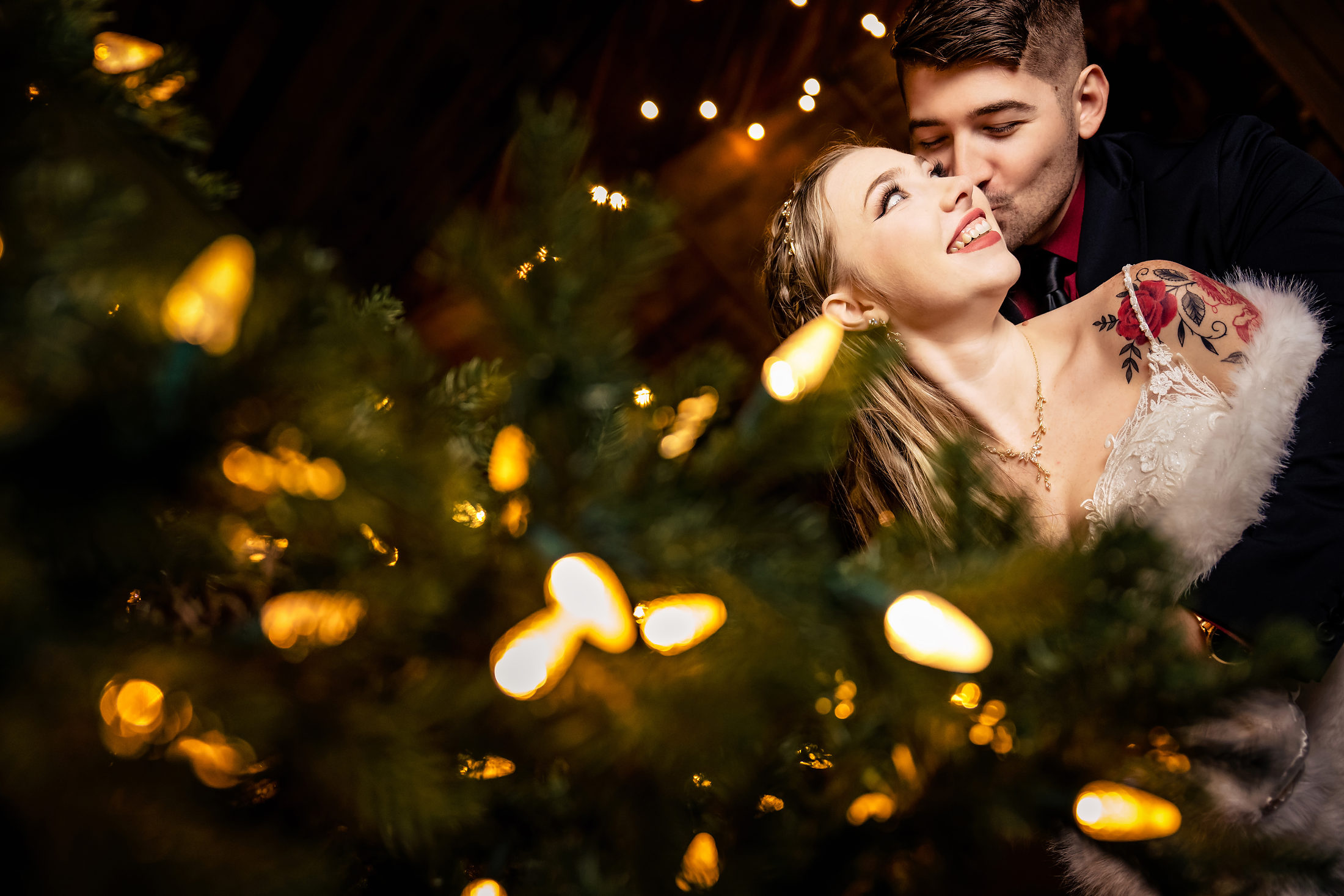 Couple kissing in a glow of fairy lights