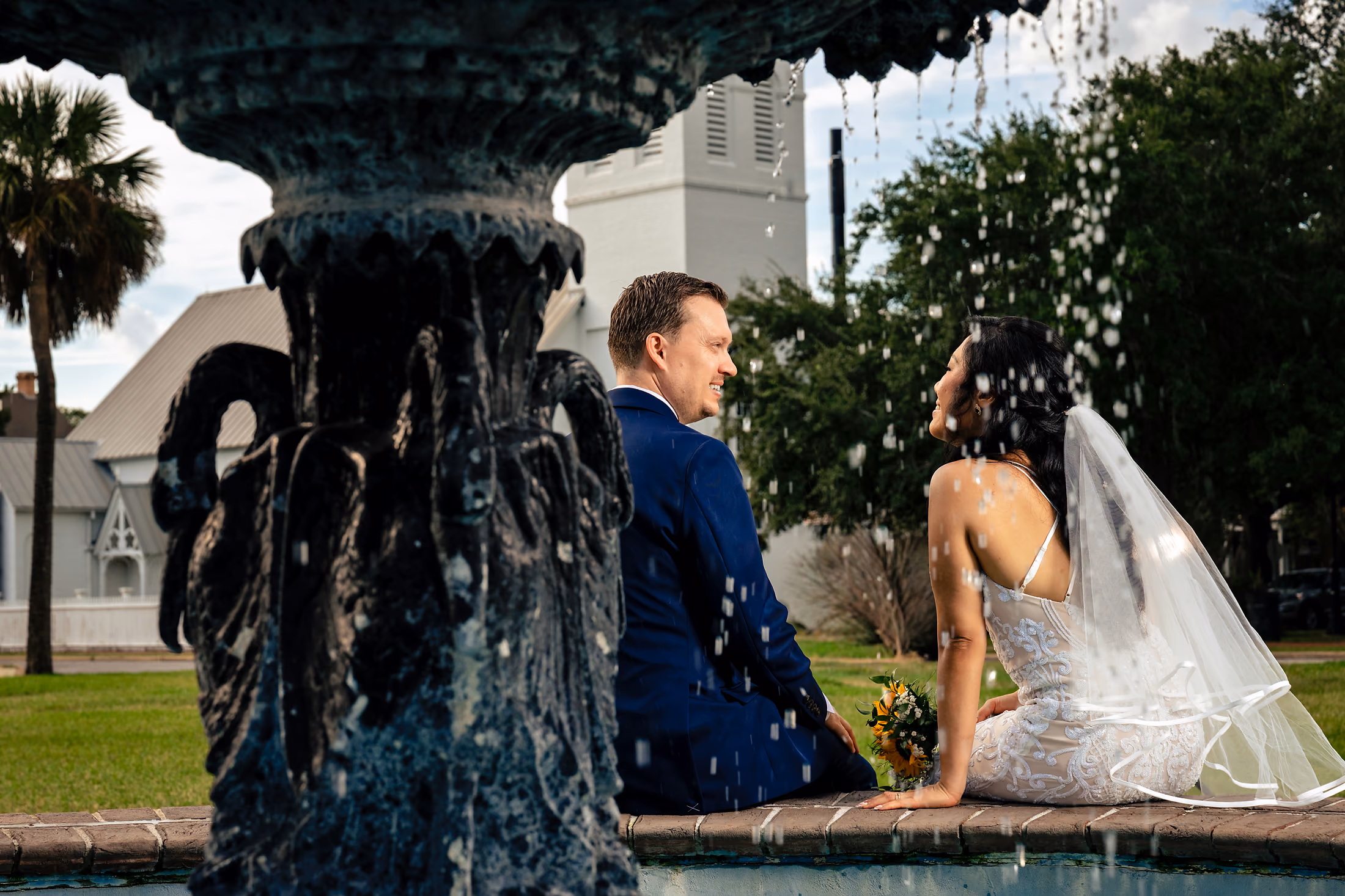 Couple by the stone fountain at night
