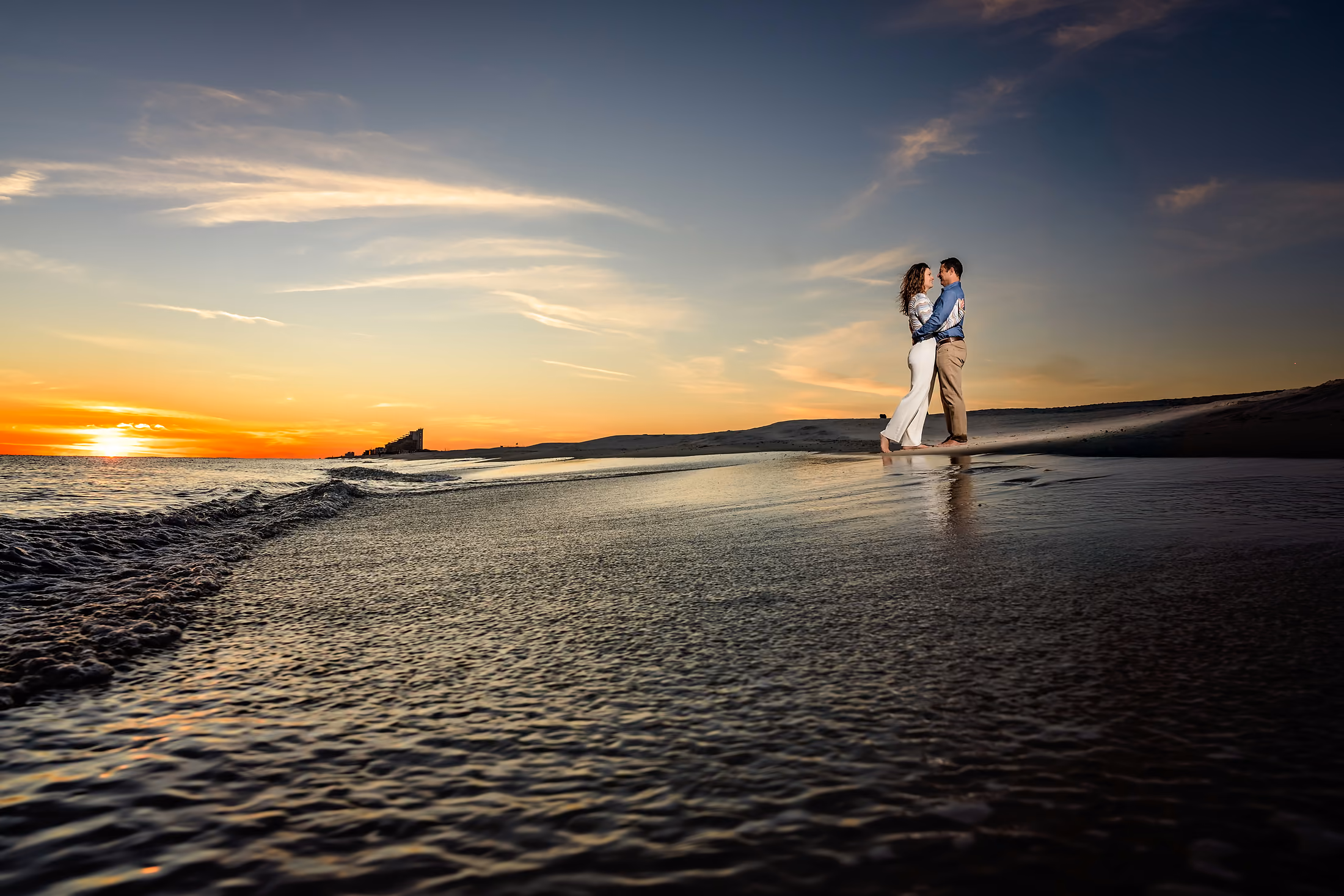Lone figure on the beach at sunset