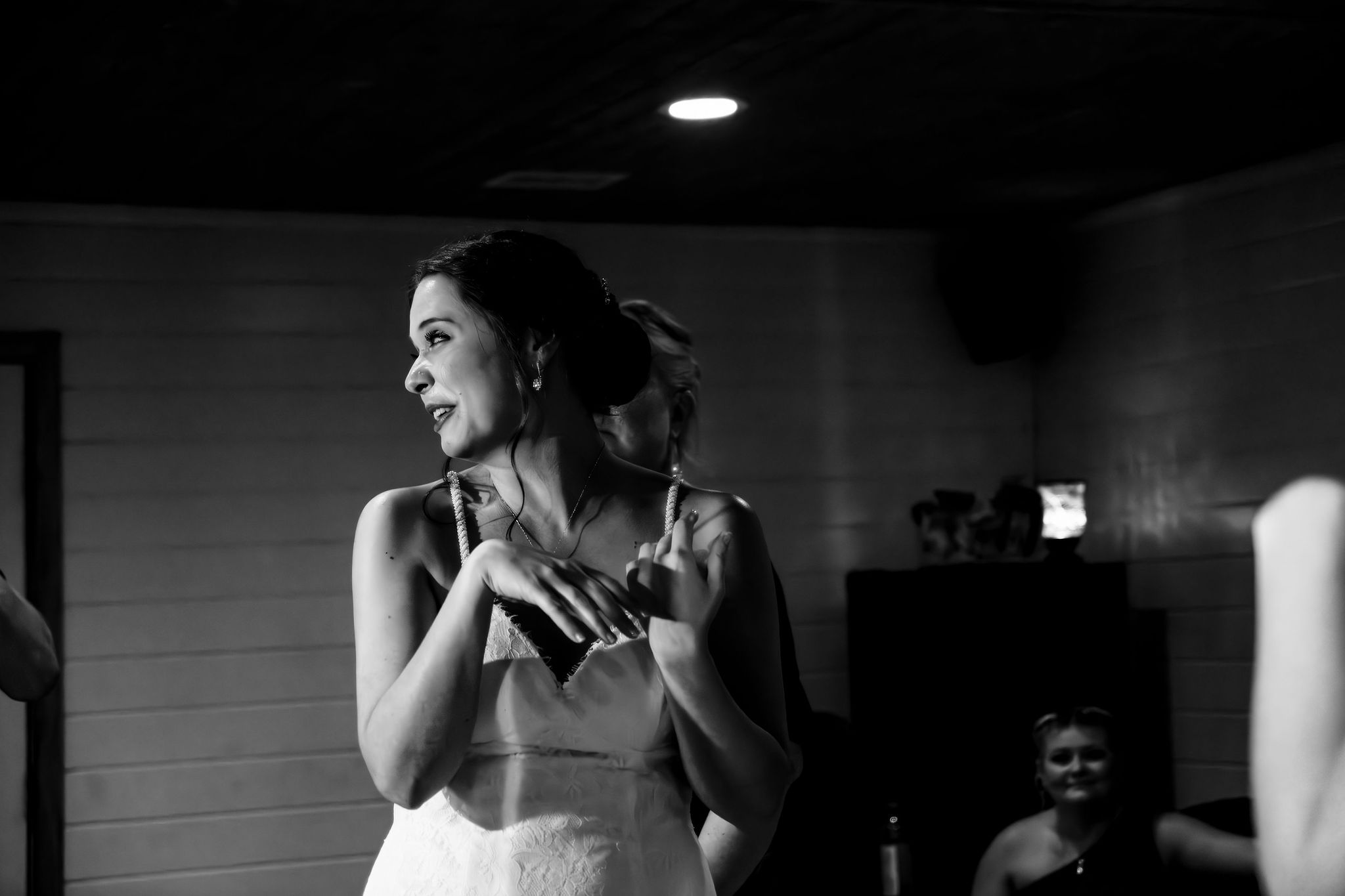 Bride by the window with her bouquet before the ceremony