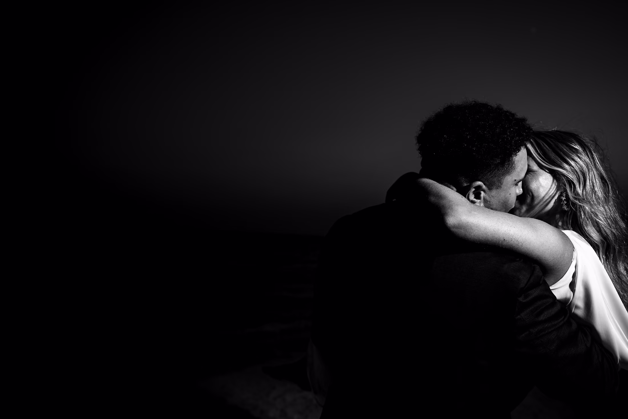 Black-and-white kiss in low light