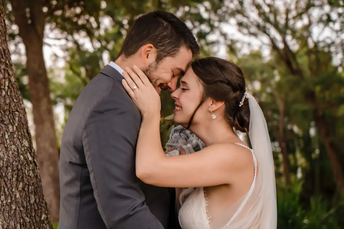 Couple embracing among the trees in golden evening light