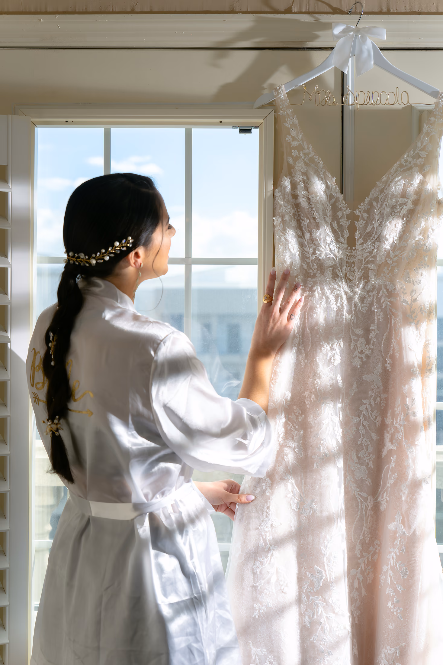 Bride in soft window light getting ready