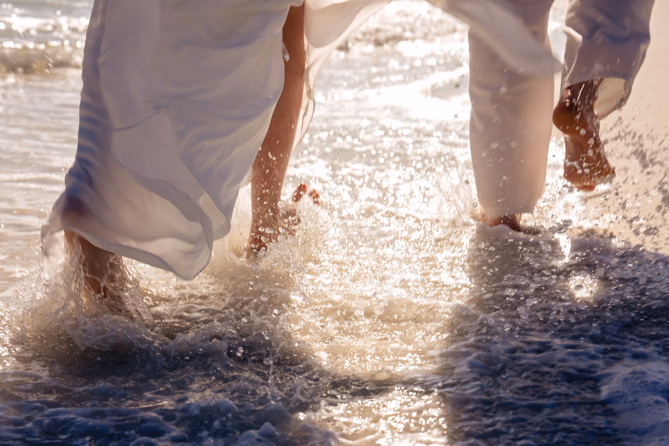 Bride walking the reflective shallows