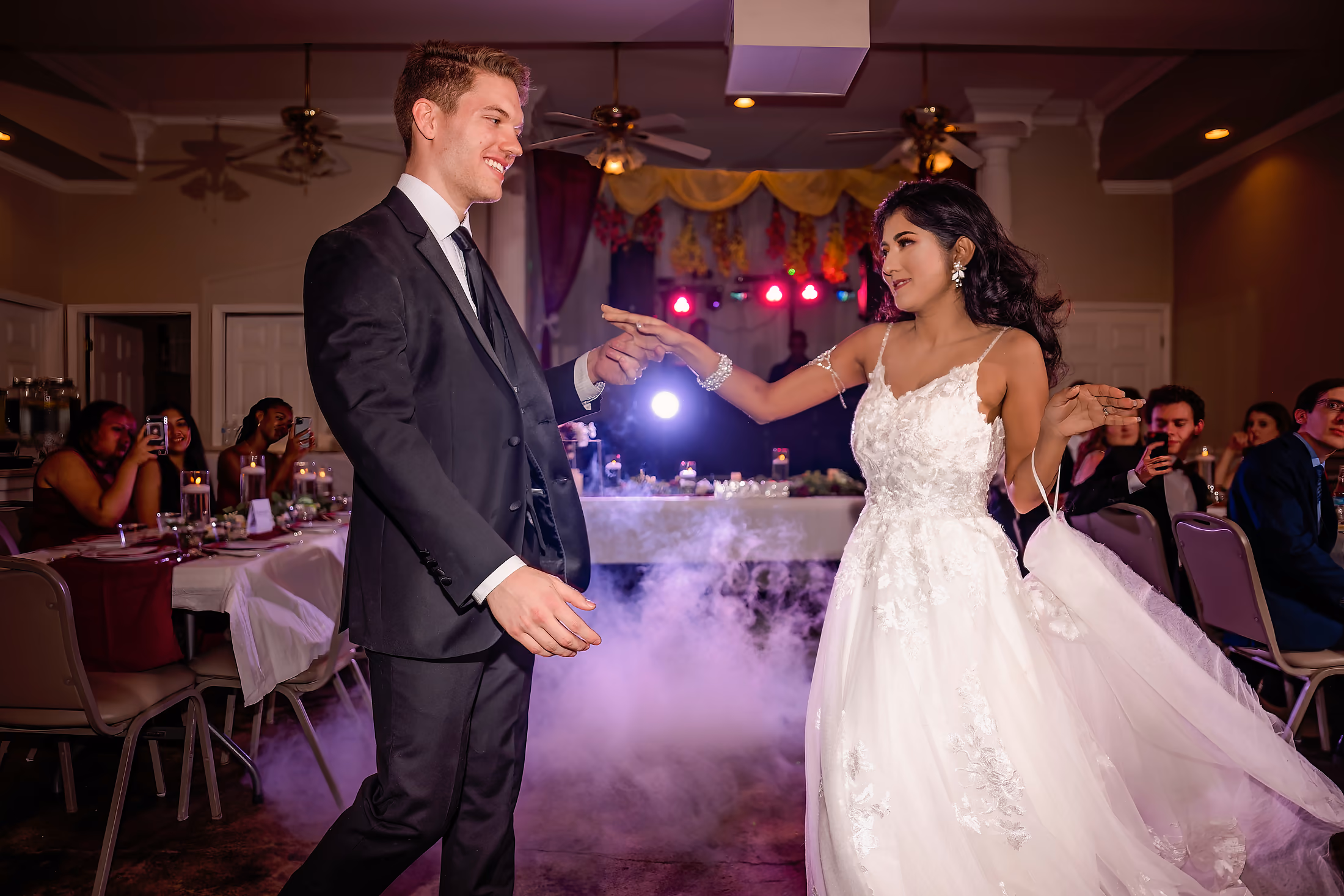 Couple dancing through low-lying fog