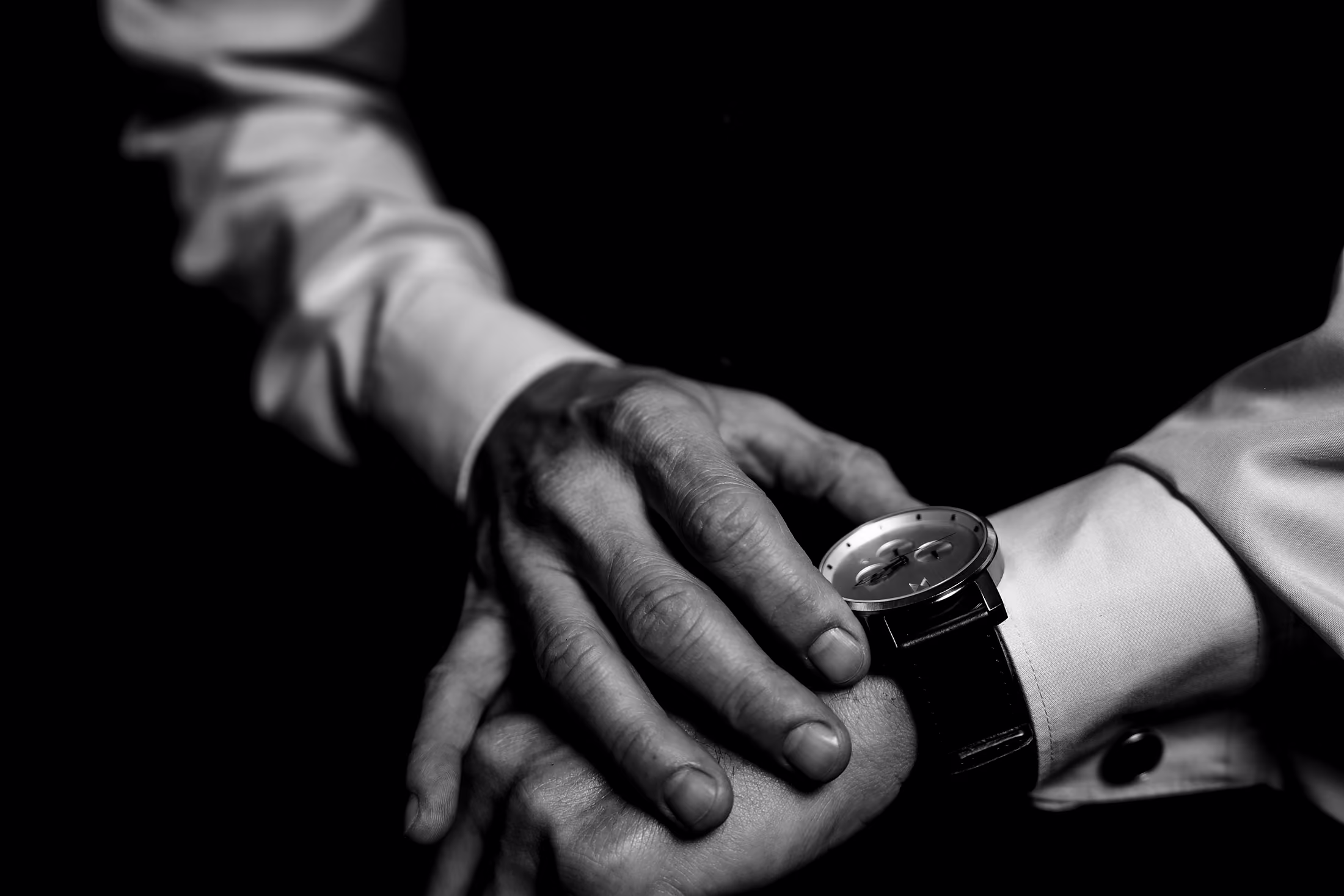 Black-and-white clasp of the couple hands
