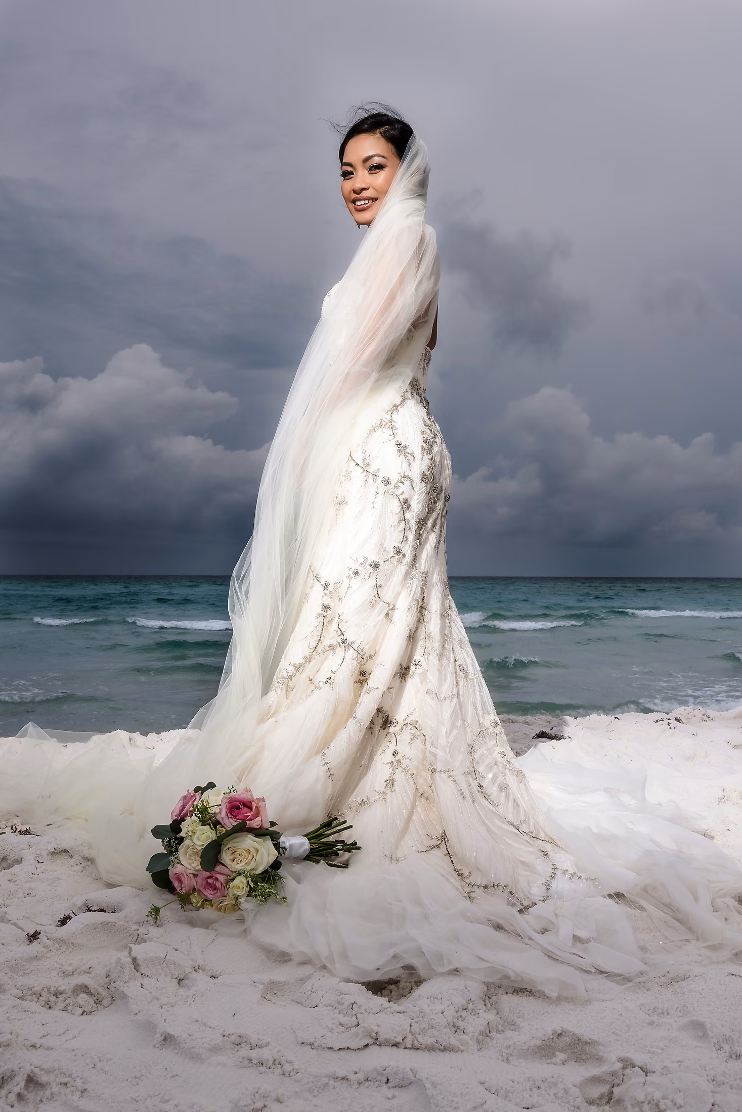 Bride with her bouquet under a stormy sky
