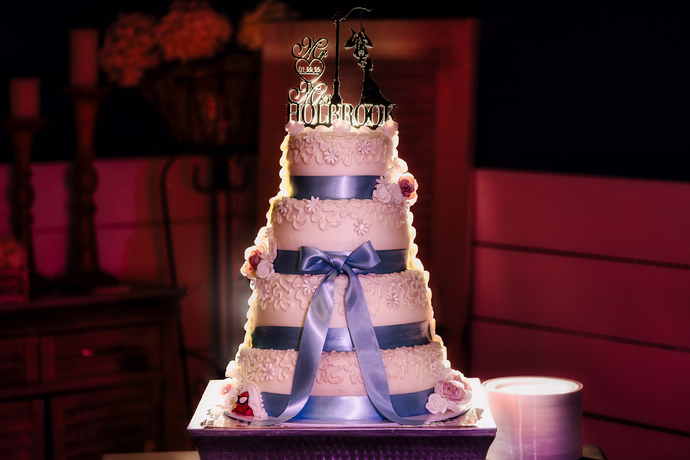 Tiered cake under rosy uplight