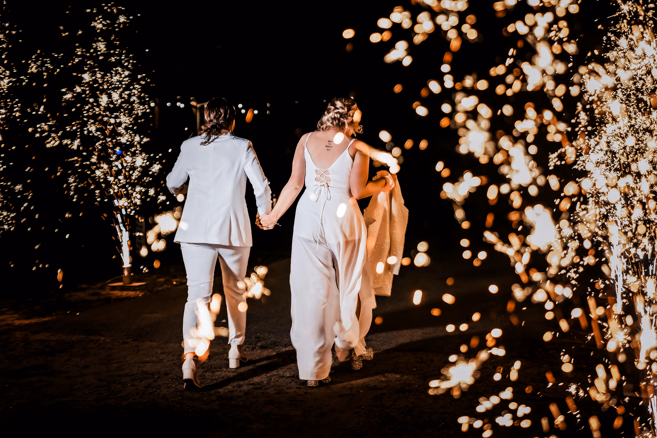 Couple walking through a sparkler send-off