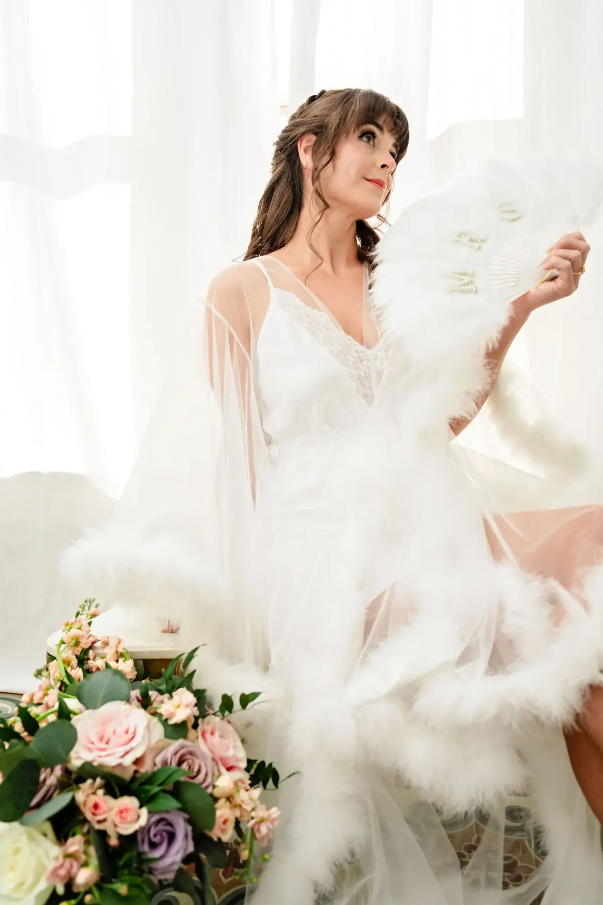 Bride spinning her gown by the bright window