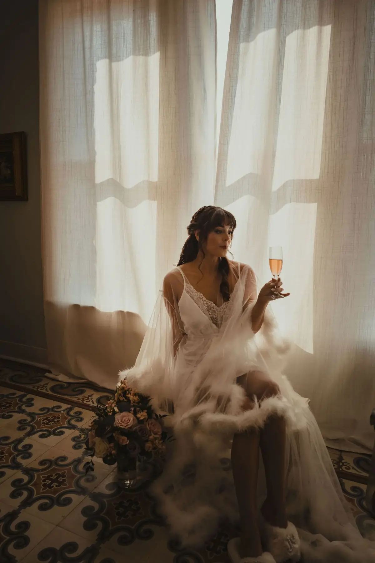 Bride twirling her dress beside the window