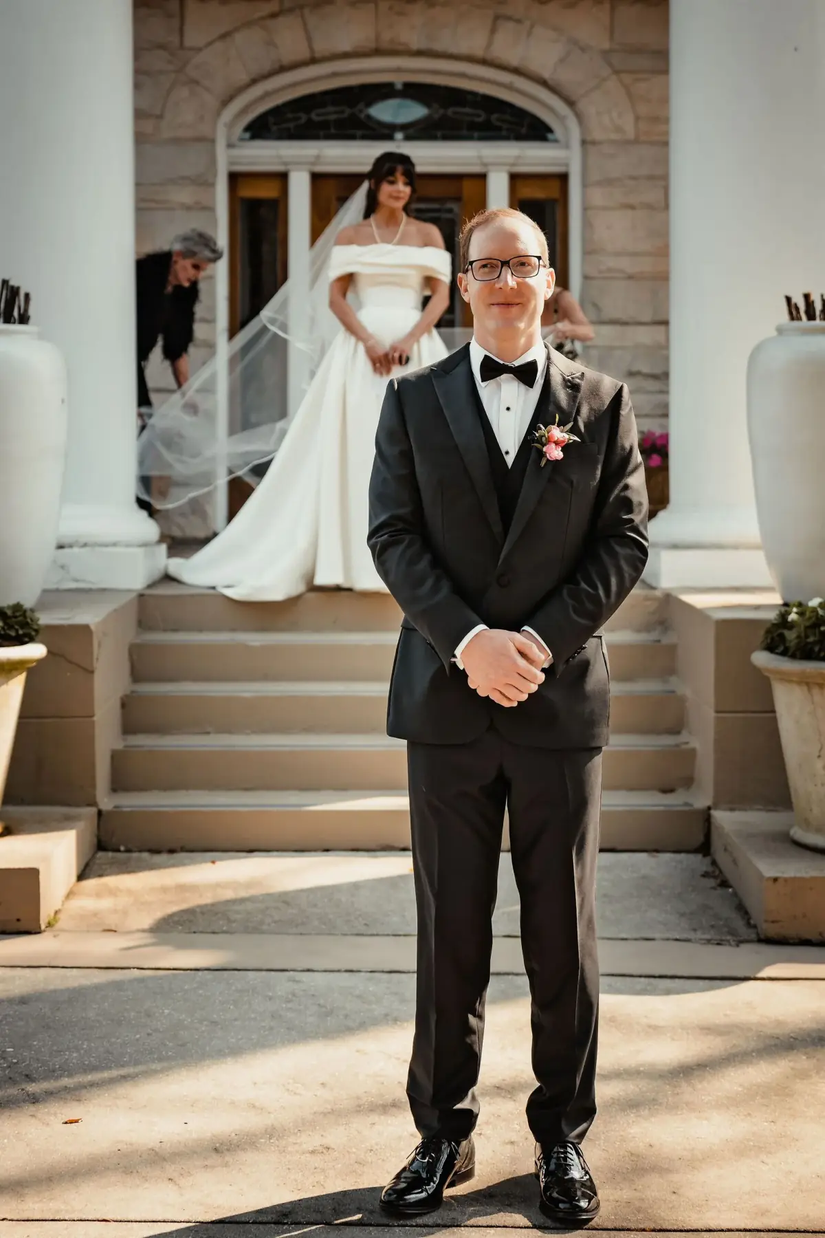Black-and-white groom among the columns