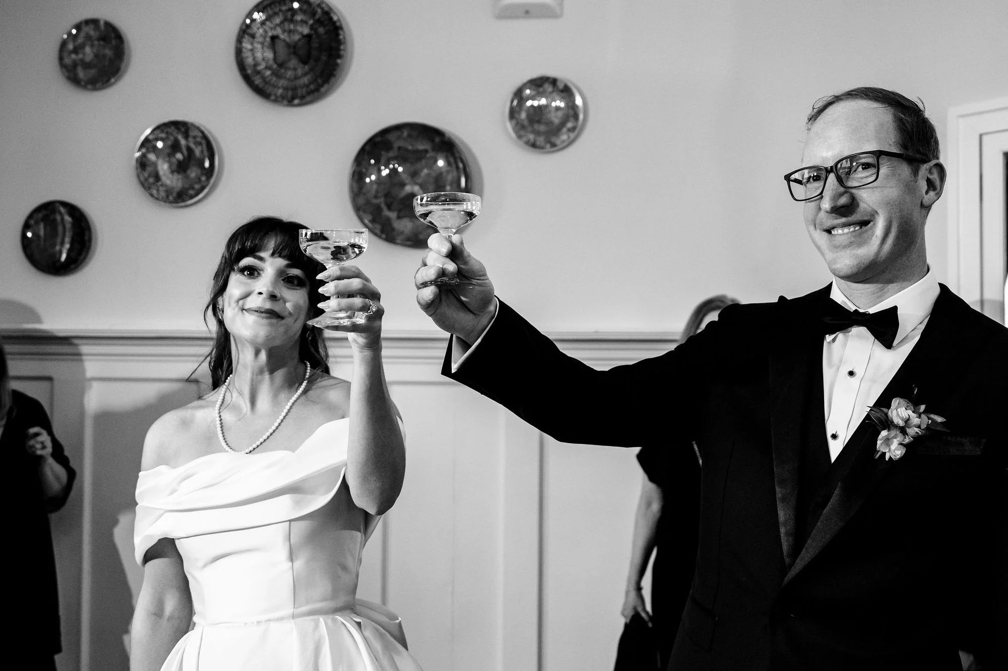 Black-and-white laugh over a champagne toast