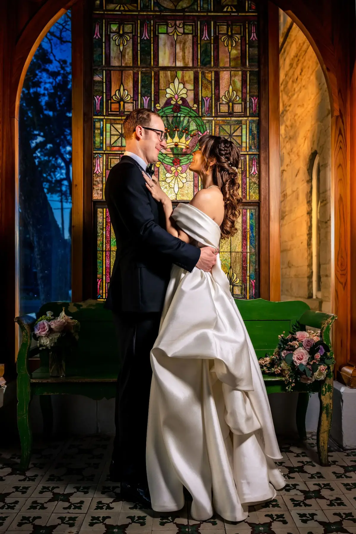 Couple kissing by the stained-glass window