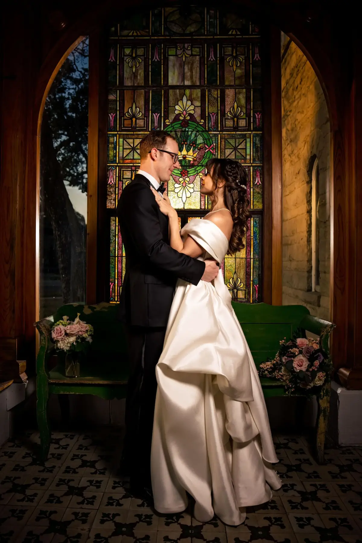 Groom leaning in close in the warm room