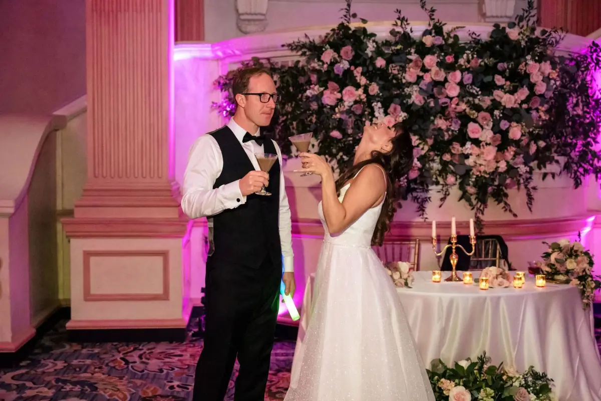 Couple kissing at the floral sweetheart table