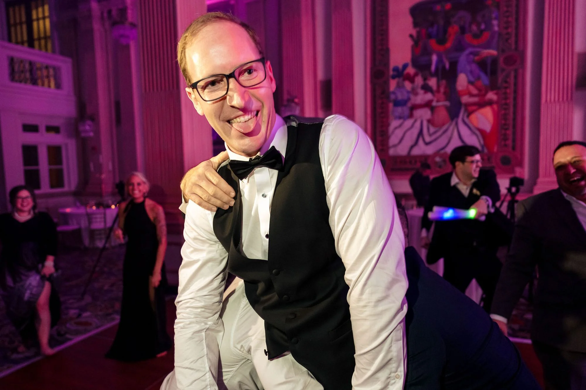 Groom in a bow tie under rosy light