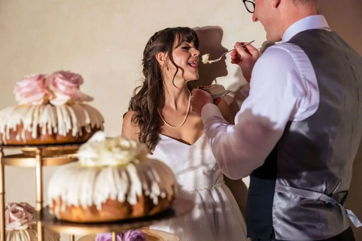 Couple cutting their floral tiered cake