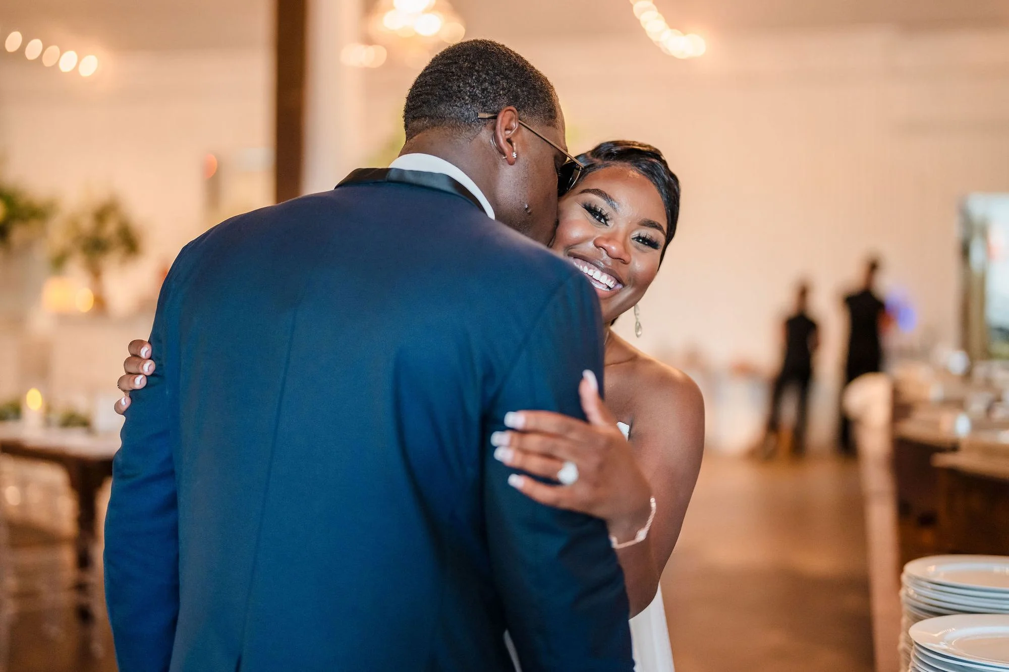 Couple dancing close under the string lights