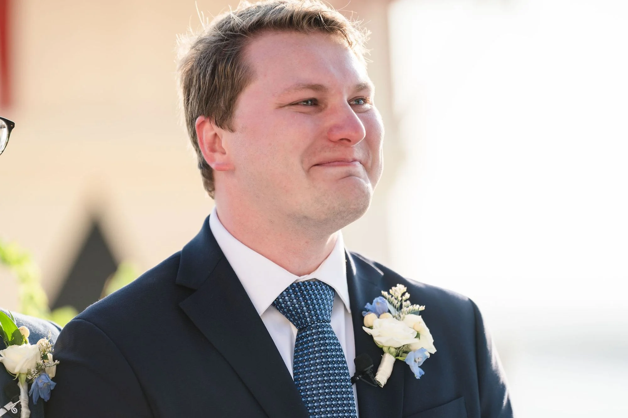 Groom portrait in navy with his boutonniere