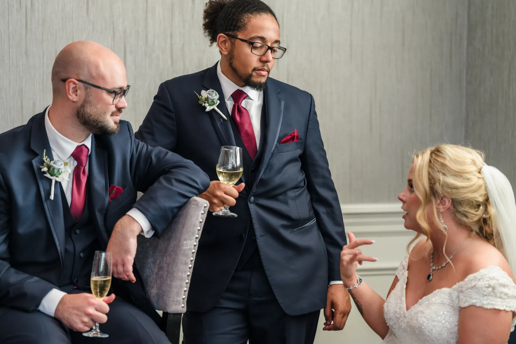 Groom and groomsman sharing a champagne toast before the wedding