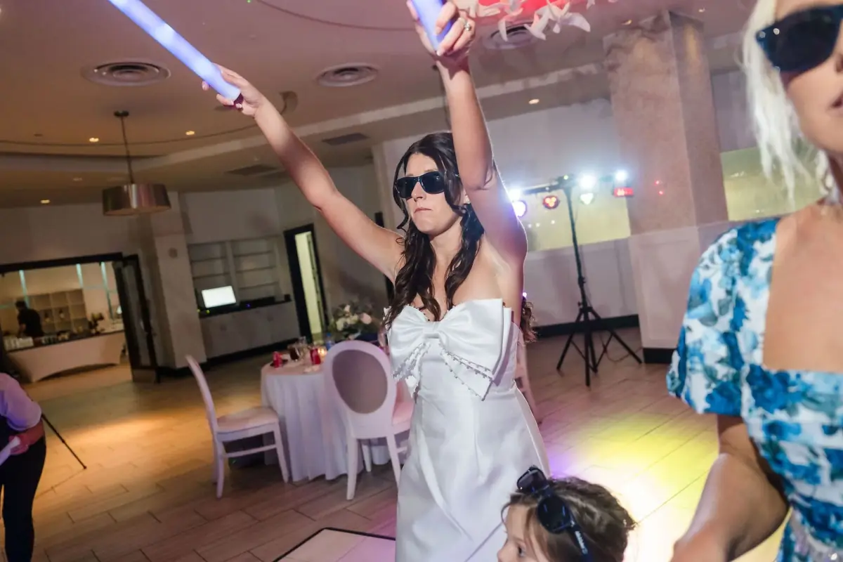 Couple raising glow sticks at the party